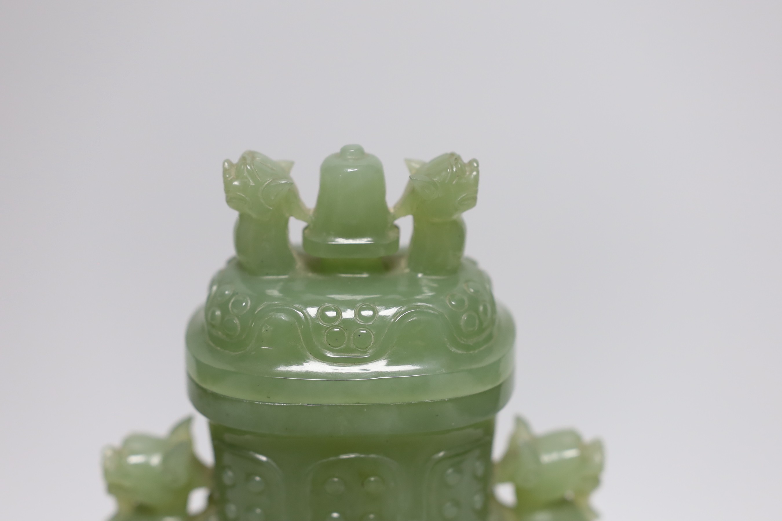 A Chinese carved bowenite jade vase and cover on hardwood stand, 23cm, with fitted case